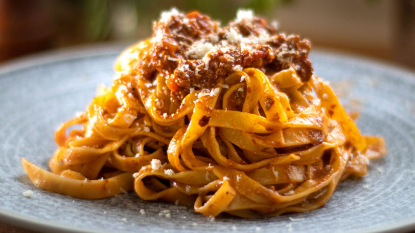 Bolognese sauce or Ragu alla Bolognese, is an Italian meat-based sauce for pasta which originated in Bologna in Northern Italy. Also known as Bolognese Ragu. This version is the closest thing to being the authentic recipe, however there can still be many variations. I don’t think there truly is an authentic version, but this is so close! Some use butter, others olive oil. For Ragu, I personally prefer olive oil. Some also add cream at the end, I don’t think it needs it, the milk does the job. The secret of course is in the sauce, it has to be cooked for a long time, the longer the better. This breaks down the meat fibres which thickens and intensifies the sauce. In the days they used to cook this 5 to 6 hours as meat was tough. Today 2 to 3 hours is plenty. Traditionally the meat is not minced but chopped using a knife. If you don’t have pancetta, you could use pork mince also. Some parts of Italy may also use butter instead of olive oil, I prefer virgin olive oil for this. Milk is also added towards the end of the cooking process, to dampen he acidy of the tomato. Cream is an optional extra, and usually used for dryer style eggless pasta. Now I know, spaghetti Bolognese sounds like an authentic Italian dish, but in fact it’s never seen in Bologna. In fact, you will never find it in Italy or at least I certainly haven’t. You will however find it in Europe, US, Australia, and some other countries. It’s also known as spag bowl, which is a terrible name, so please don’t ever use the name unless you’re a young teenager!